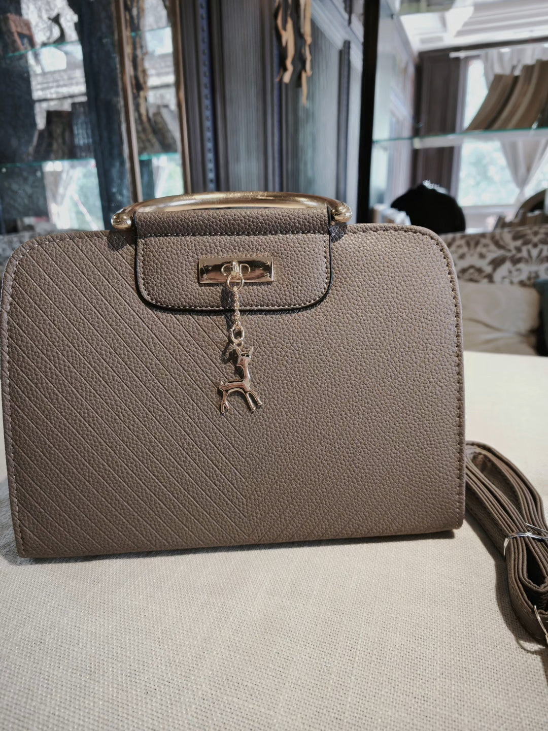 Taupe Textured Top-Handle Boston Bag with Golden Deer Charm and Detachable Strap