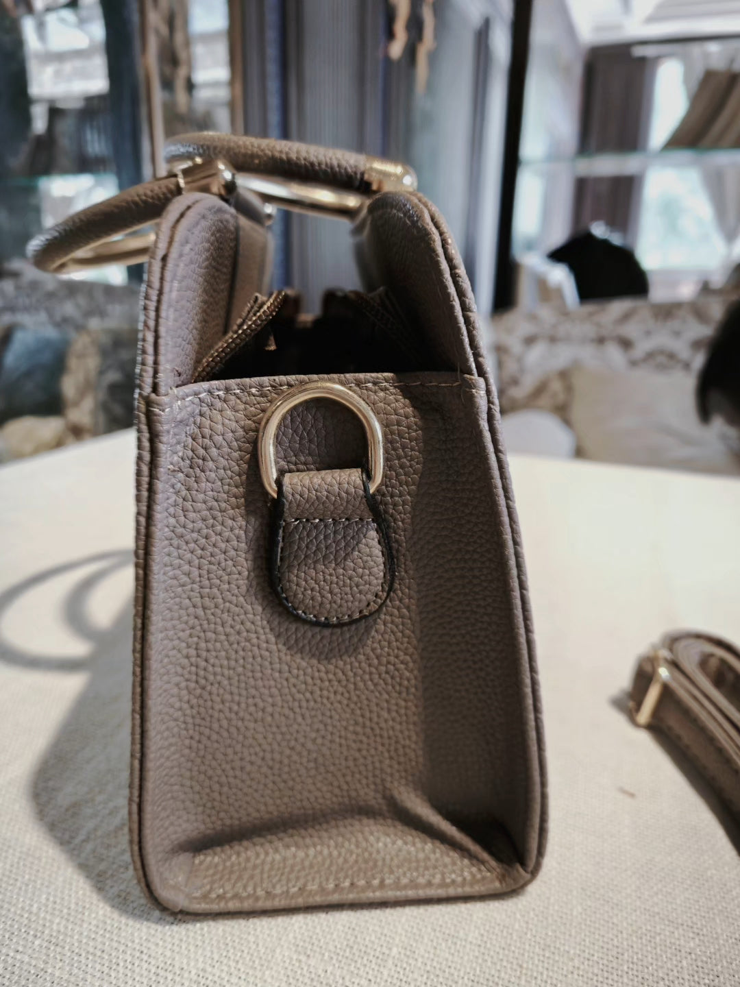 Taupe Textured Top-Handle Boston Bag with Golden Deer Charm and Detachable Strap