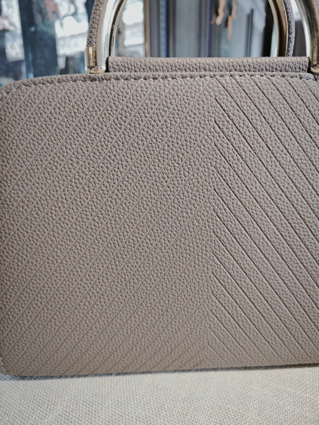 Taupe Textured Top-Handle Boston Bag with Golden Deer Charm and Detachable Strap