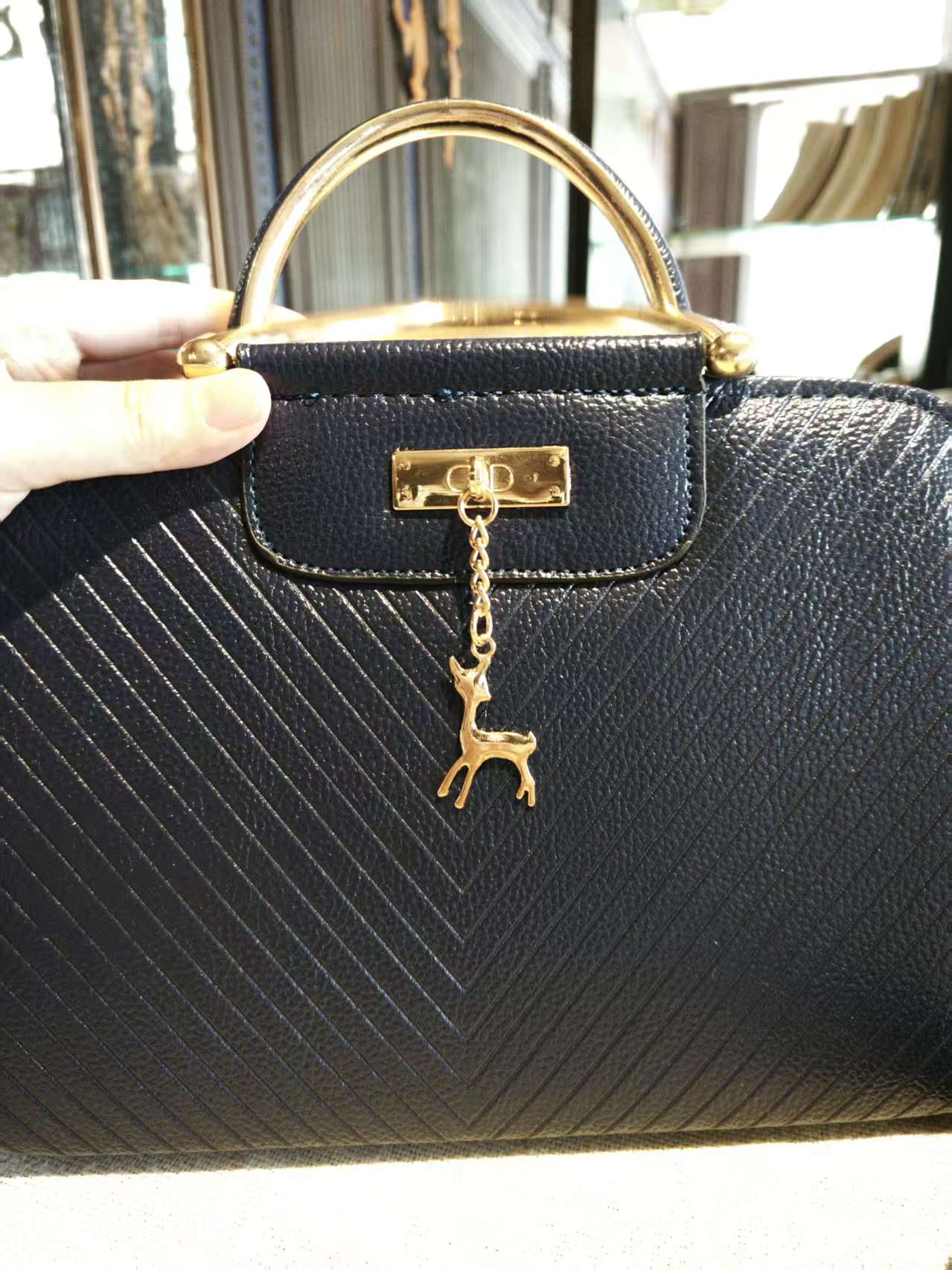 Navy Blue Textured Top-Handle Boston Bag with Golden Deer Charm and Detachable Strap
