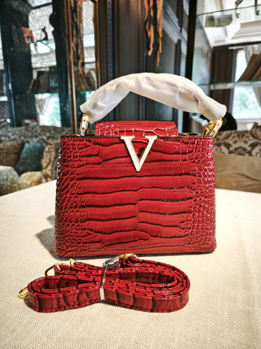 Red Crocodile-Embossed Structured Handbag with Gold 'V' Accent and Detachable Strap