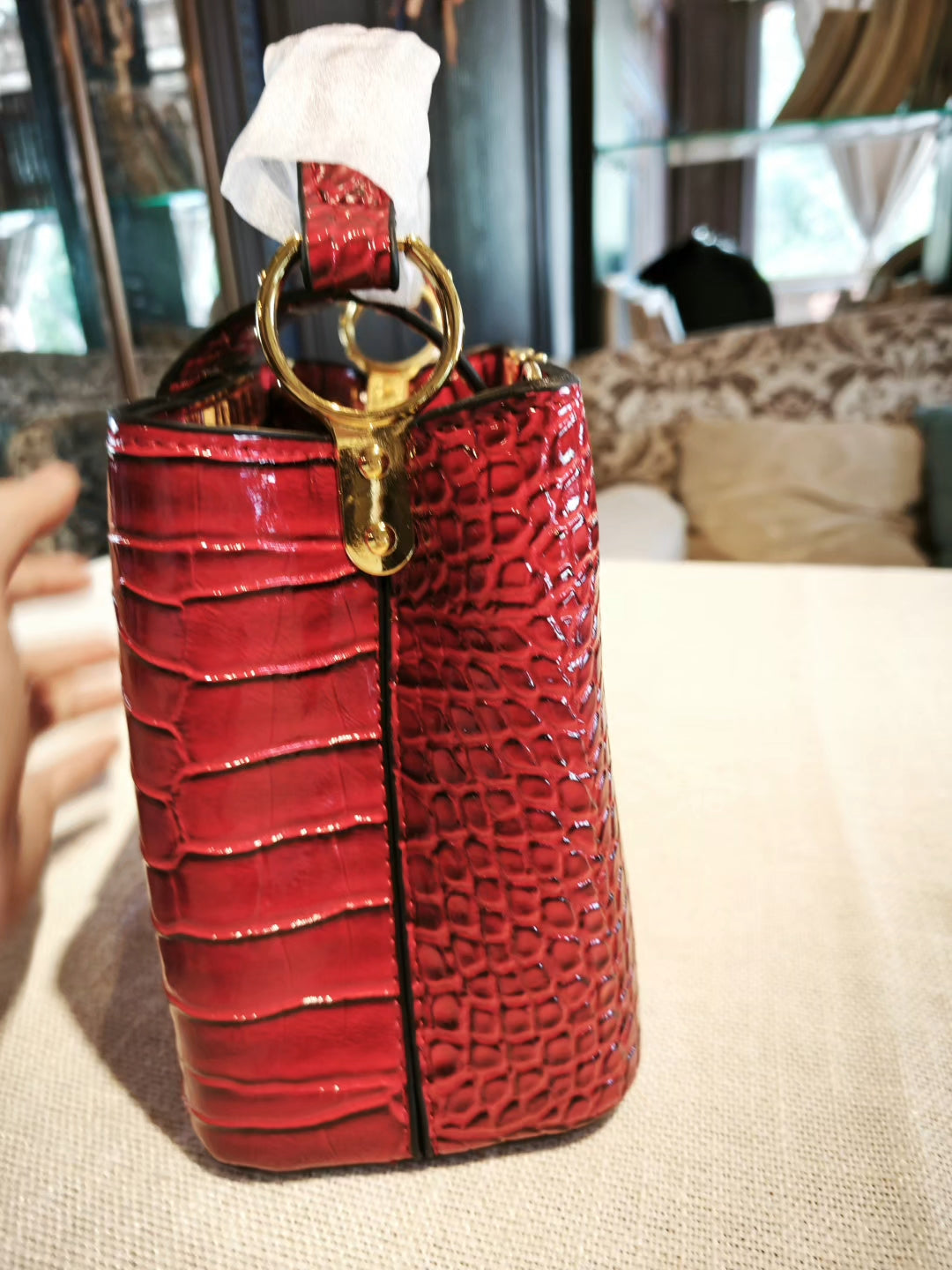 Red Crocodile-Embossed Structured Handbag with Gold 'V' Accent and Detachable Strap