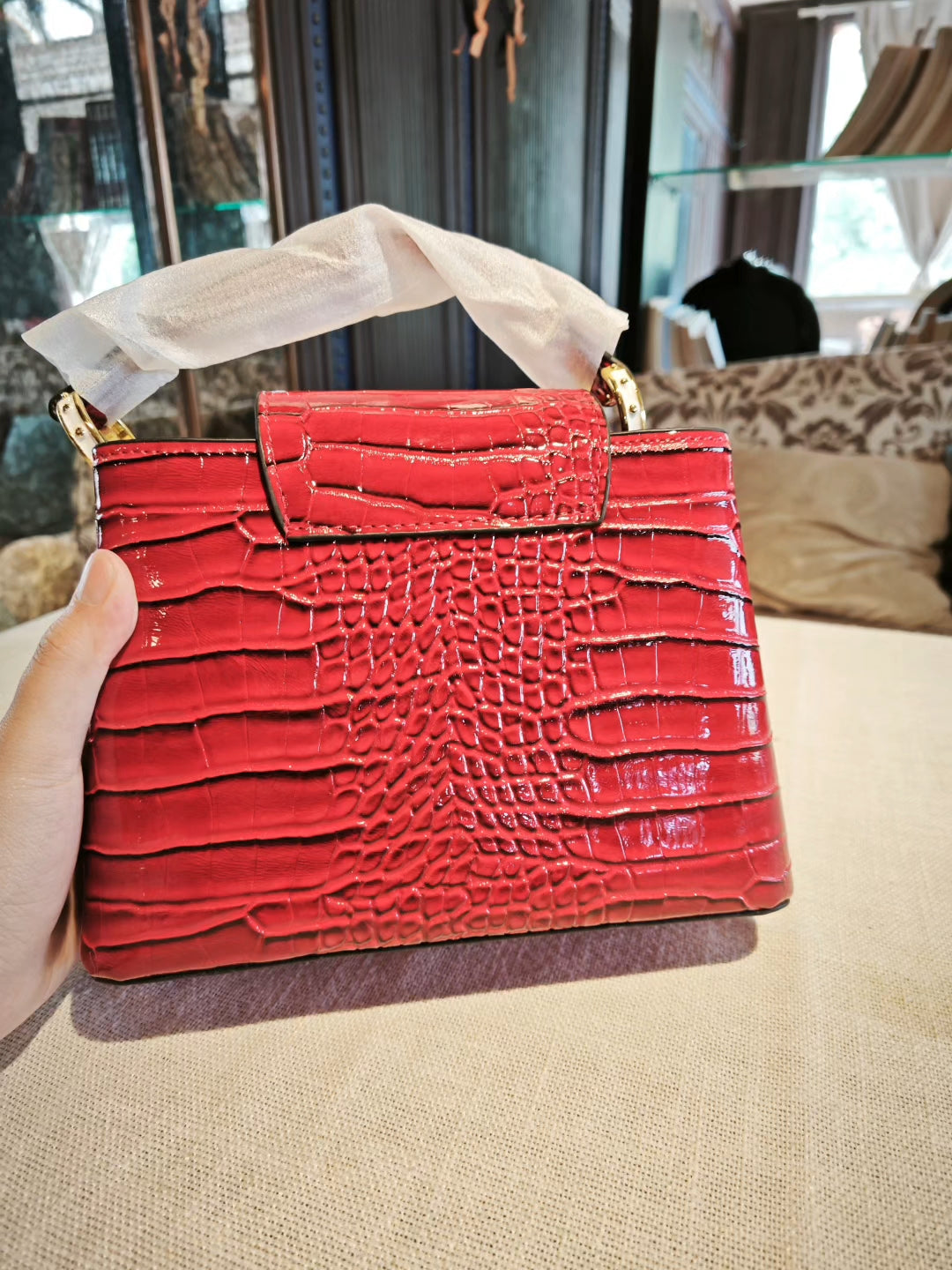 Red Crocodile-Embossed Structured Handbag with Gold 'V' Accent and Detachable Strap