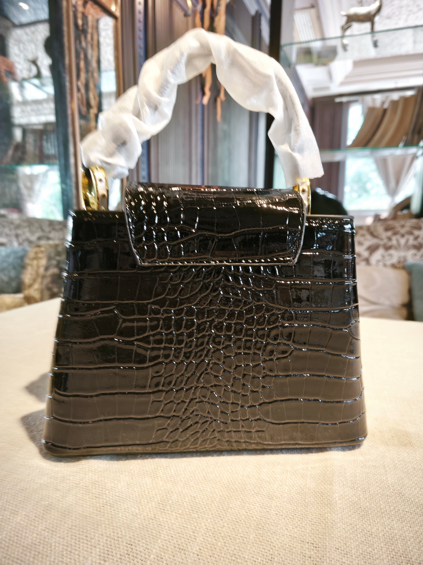 Black Crocodile-Embossed Structured Handbag with Gold 'V' Accent and Detachable Strap